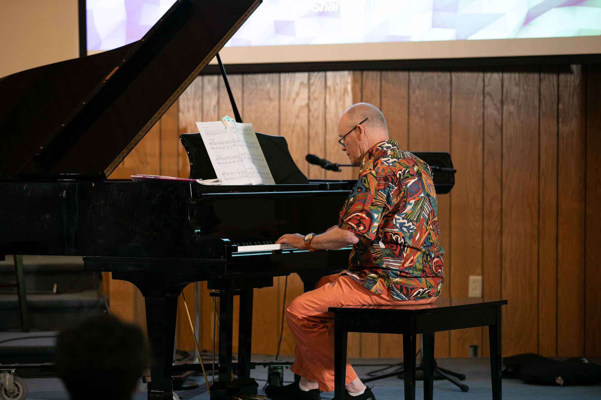 Teen or adult student playing piano during a lesson